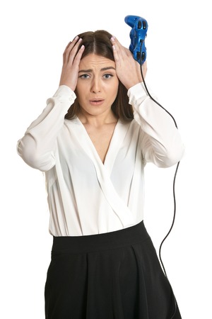 Young woman playing video game with joystick isolated on white backgroundの写真素材