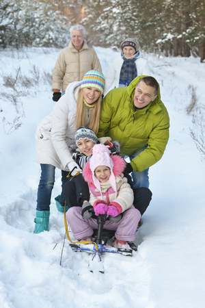 Portrait of family  in winter with  snowmobileの写真素材