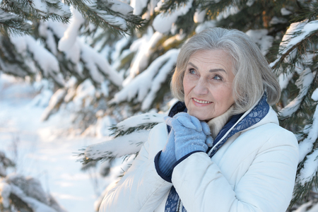 Portrait of a beautiful old woman in the winterの写真素材