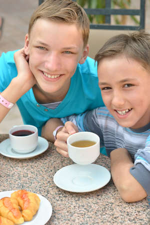 Happy children  at breakfast on tropical resortの写真素材