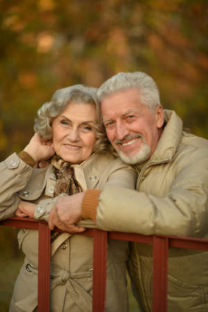Portrait of a happy senior couple in autumn park