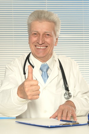 Portrait of a doctor showing thumbs upの写真素材