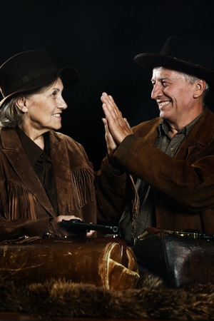 Two smiling hunter in western clothes closeup