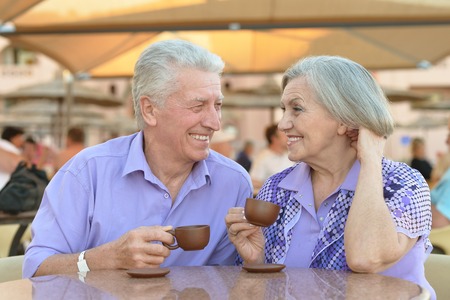 Nice senior couple with coffee on vacationの写真素材