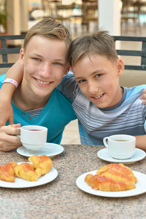 Happy children  at breakfast on tropical resortの写真素材