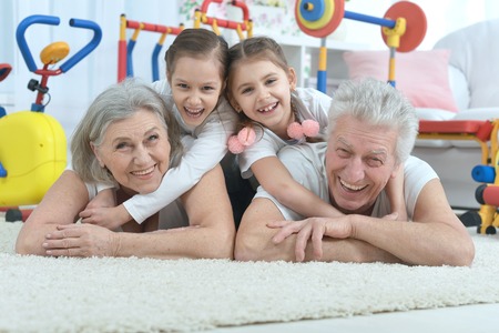 grandparents  and  little granddaughters doing exercise homeの写真素材