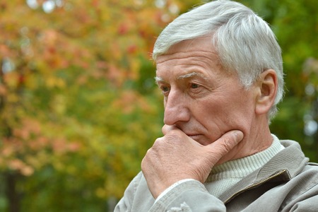 Portrait of  senior man thinking about something outdoor