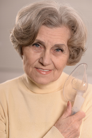 Portrait of elderly woman with flu inhalationの写真素材