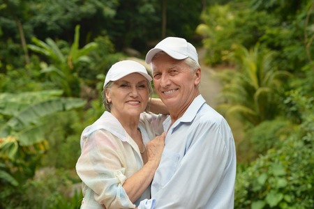 Happy elderly couple   in tropical garden outdoorの写真素材