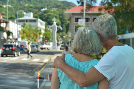 Beautiful happy elderly couple rest at tropical resort,back viewの写真素材