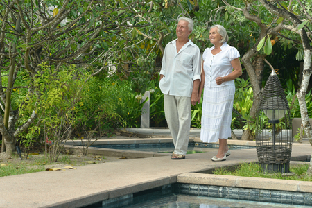 Beautiful happy elderly couple rest at tropical resortの写真素材