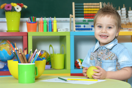 cute little boy drawing at home or kindergartenの写真素材