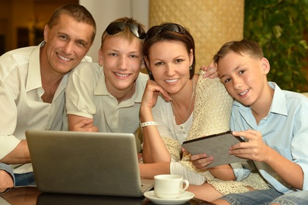 happy family  with laptop at the table