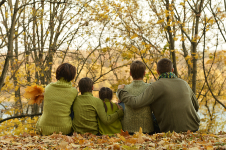 Happy smiling family relaxing in autumn parkの写真素材