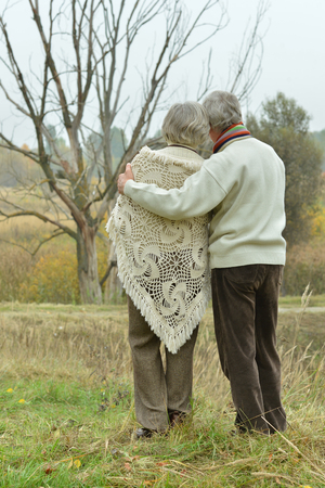 Mature couple walking in the autumn parkの写真素材