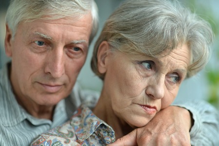 Close-up portrait of an elder couple at homeの写真素材