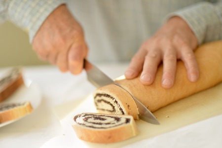 Man hands closeup cutting pie at kitchen