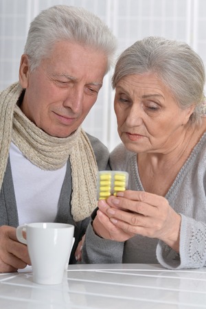 Portrait of an ill senior man and caring wifeの写真素材