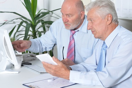 portrait of two senior Business people working together with computer on the tableの写真素材