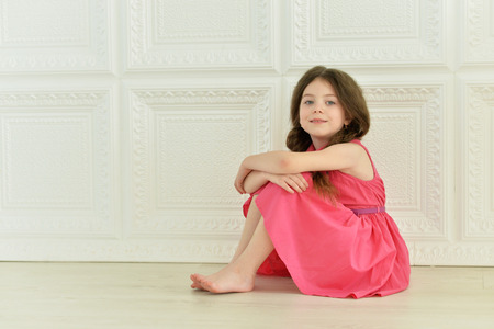 portrait of cute little girl posing in pink dressの写真素材