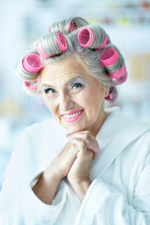 Senior woman in  hair rollers at homeの写真素材