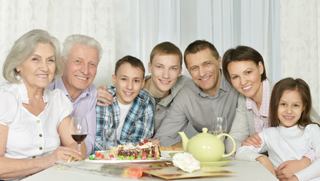 Portrait of a happy family with cake at home