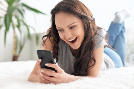 Portrait of a beautiful girl with mobile phoneの写真素材