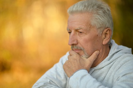 Portrait of a senior man thinking about something outdoor