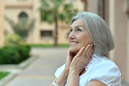 Portrait of a happy elderly woman at tropical resort