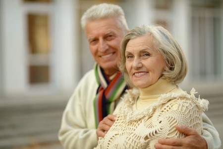 Portrait of a happy senior couple in autumn parkの写真素材