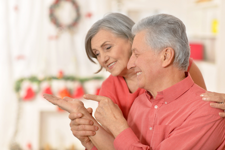 Amusing old couple wearing Christmas holiday capsの写真素材