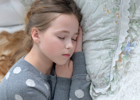 Portrait of a cute little girl sleeping in bed