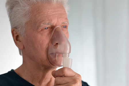 Portrait of elderly man with flu inhalationの写真素材