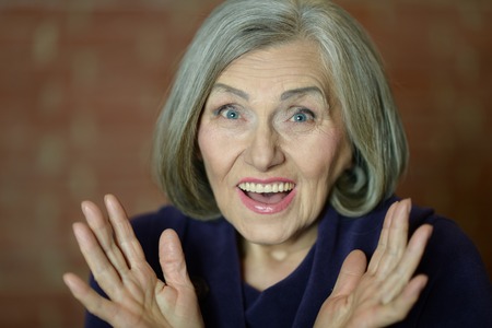 Portrait of a happy elderly woman Surprisedの写真素材