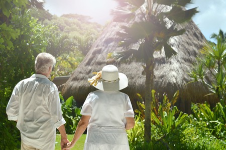 Happy elderly couple   in tropical garden outdoorの写真素材