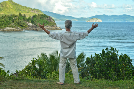 Portrait of a happy senior man at tropical resortの写真素材