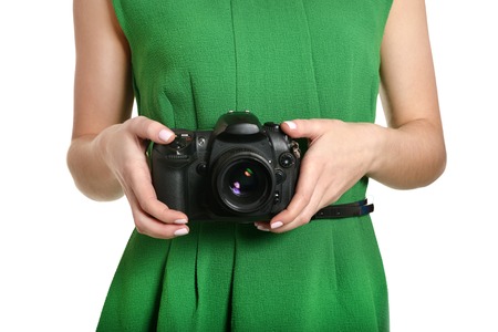 Young beautiful caucasian woman with camera over white backgroundの写真素材