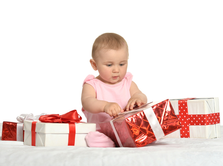 Portrait of Cute baby girl sitting  with giftsの写真素材