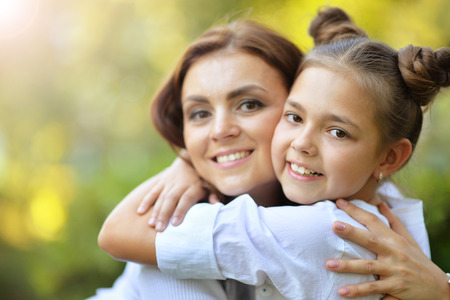 Lifestyle portrait of mother and daughter in happines at the outside in the meadowの写真素材