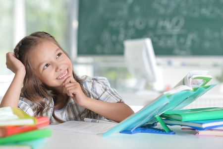Portrait of a little student girl at classroomの写真素材
