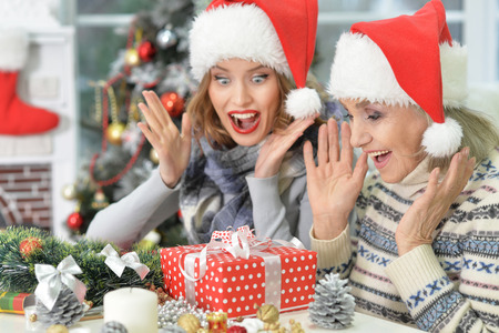 Portrait of exited senior and young women looking at the Christmas presentの写真素材