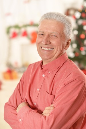 Portrait of smiling senior man standing with arma crossedの写真素材