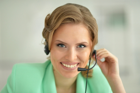 Portrait of smiling young businesswoman in headset