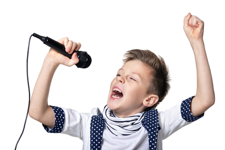 Portrait  of little boy with microphone isolated on white backgroundの写真素材