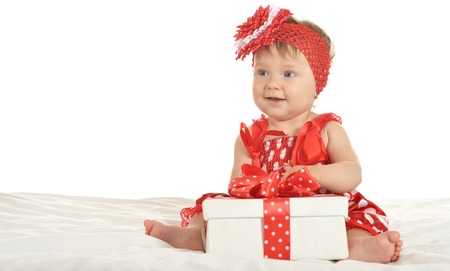 Portrait of baby girl in cute  dress  with giftの写真素材