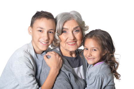 Portrait of happy grandmother with kids isolated on white backgroundの写真素材