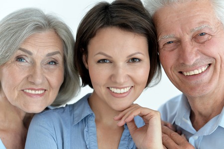 happy family portrait parents with adult daughter, close up