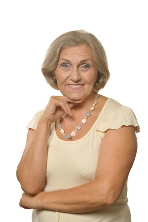 Portrait of a beautiful senior woman posing against whiteの写真素材