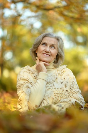 senior woman in  autumn parkの写真素材