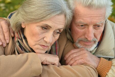 Sad senior couple in  parkの写真素材
